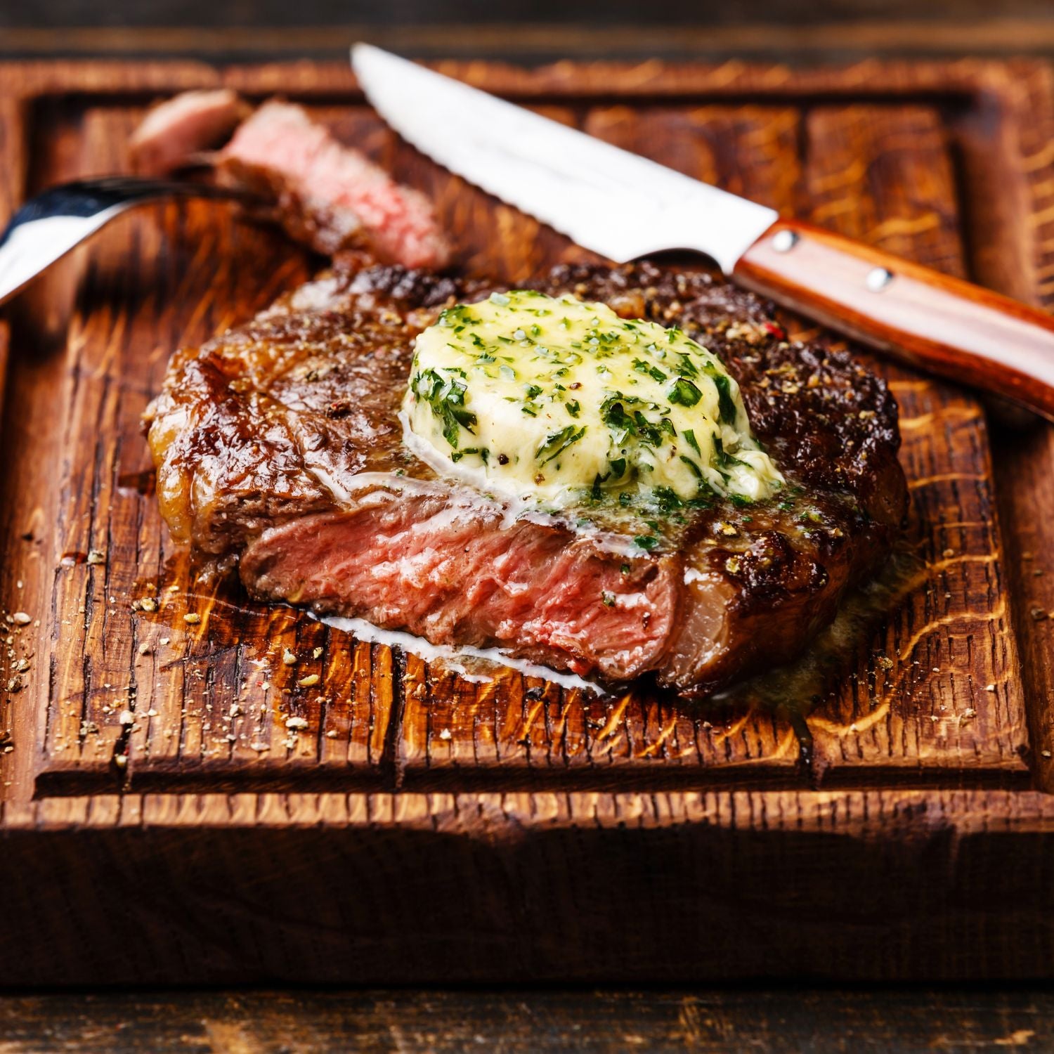 Juicy and flavorful grilled steak topped with herb butter