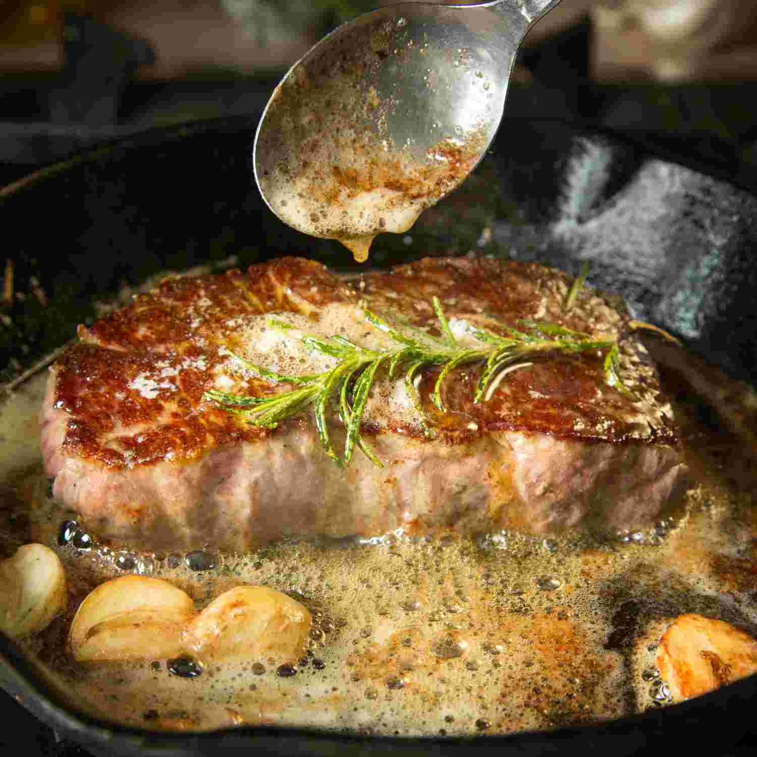 A photo of a juicy steak with fresh rosemary garnish